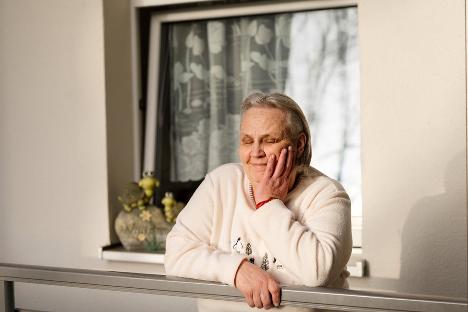 Brigitte Mladenovski steht zufrieden am Balkon ihrer Senioren-WG und fühlt sich nicht mehr allein